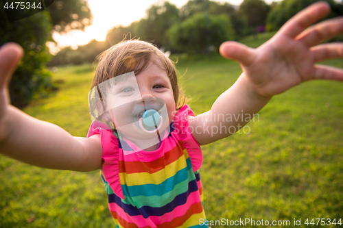 Image of little girl spending time at backyard