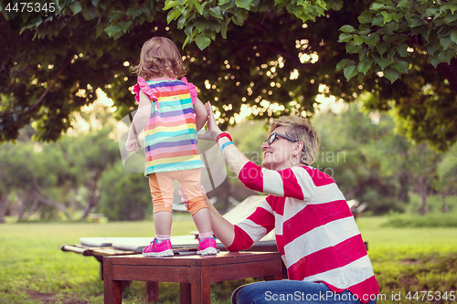 Image of mom and her little daughter using tablet computer