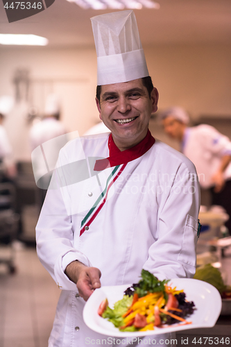 Image of Chef showing a plate of tasty meal