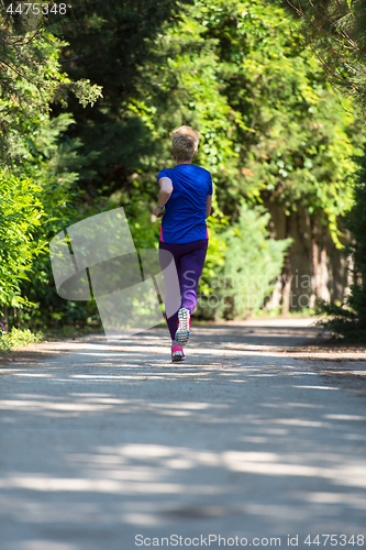 Image of young female runner training for marathon