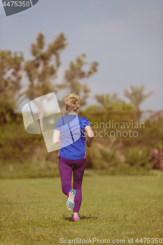 Image of young female runner training for marathon