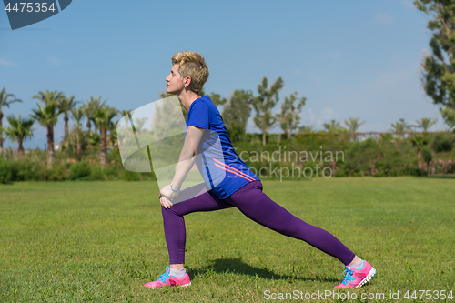 Image of female runner warming up and stretching