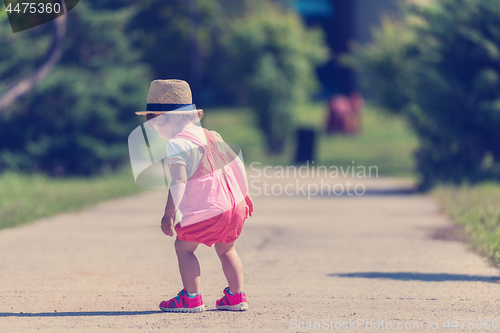 Image of little girl runing in the summer Park