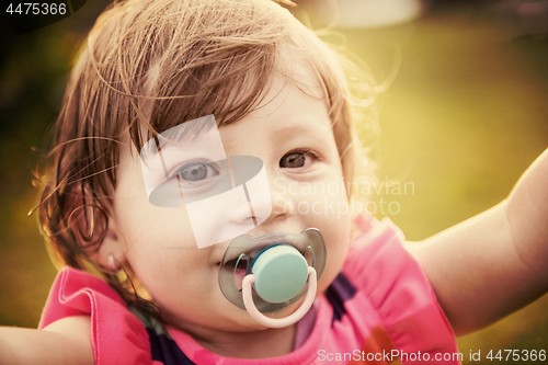 Image of little girl spending time at backyard