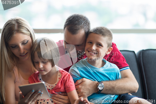 Image of happy young couple spending time with kids