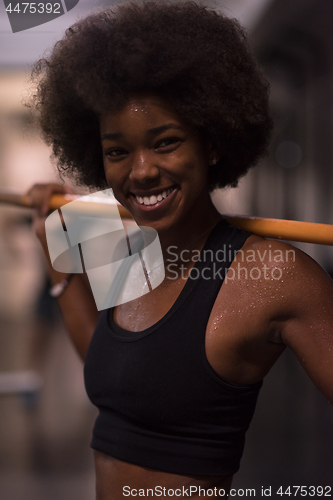 Image of black woman lifting empty bar