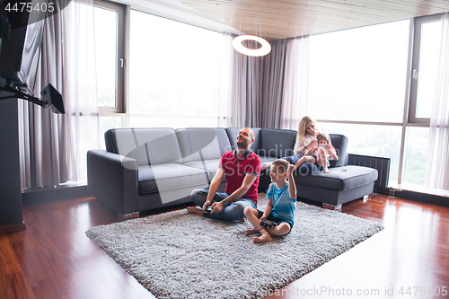 Image of Happy family playing a video game