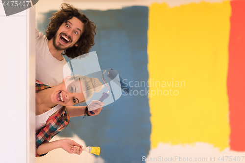 Image of portrait of a couple painting interior wall