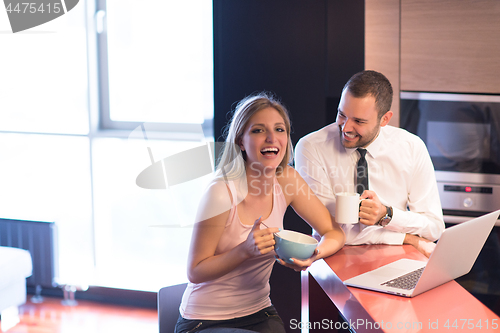 Image of A young couple is preparing for a job and using a laptop