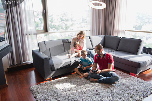 Image of Happy family playing a video game