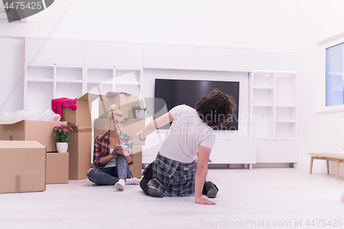 Image of young couple moving  in new house