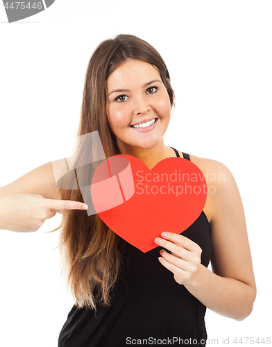 Image of young woman in love with a heart in hand
