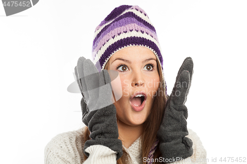 Image of Face of pretty woman with gloves and knitted winter cap  with smile