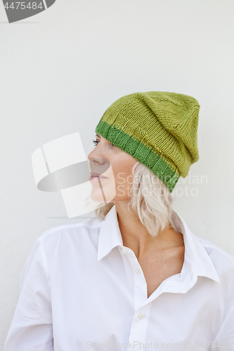 Image of Beautiful young woman in warm green beanie.