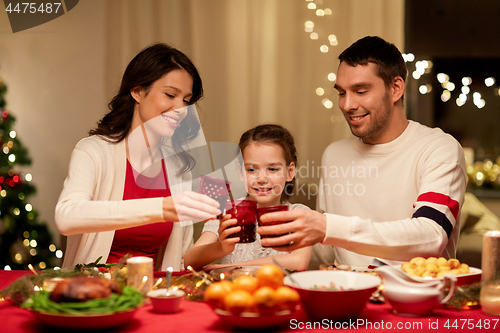 Image of happy family having christmas dinner at home