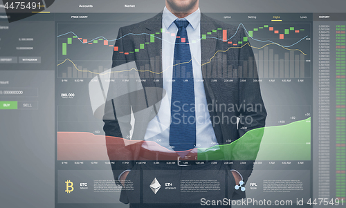 Image of businessman with cryptocurrency on virtual screen