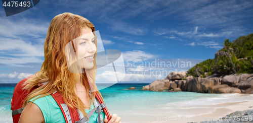 Image of happy woman with backpack over seychelles beach