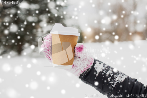 Image of close up of hand with coffee outdoors in winter