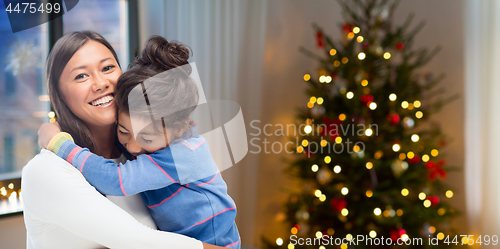 Image of happy mother hugging her daughter on christmas