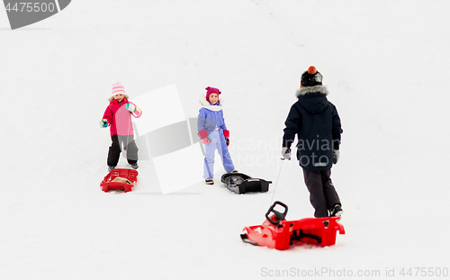 Image of happy little kids with sleds in winter