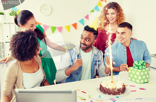 Image of office team greeting colleague at birthday party