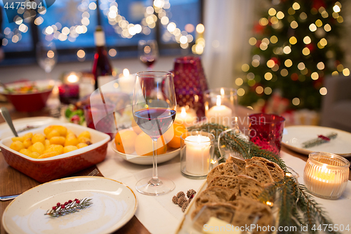 Image of glass of red wine and food on christmas table