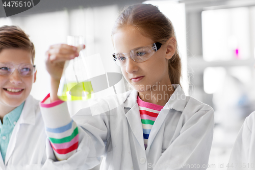 Image of kids with test tubes studying chemistry at school