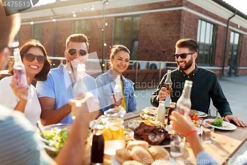 Image of happy friends with drinks or bbq party on rooftop