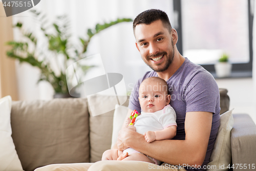 Image of happy father with little baby daughter at home