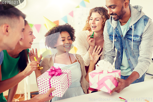 Image of team greeting colleague at office birthday party