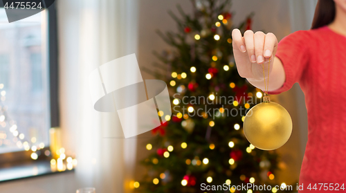 Image of close up of woman holding christmas ball