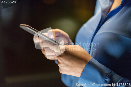 Image of close up of businesswoman hands with smartphone