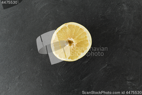 Image of close up of lemon slice on slate table top