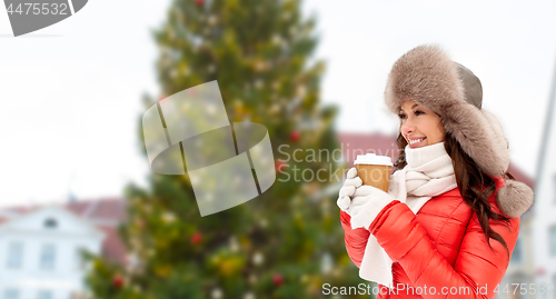 Image of woman with coffee over christmas tree in tallinn