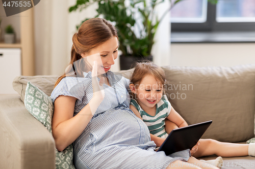 Image of pregnant mother and daughter having video chat