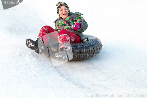 Image of Happy boy with snow tube