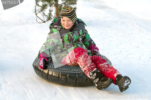 Image of Happy boy with snow tube