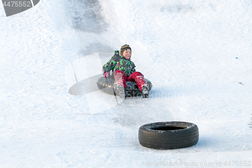 Image of Happy boy with snow tube