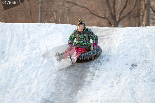 Image of Happy boy with snow tube