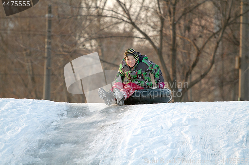 Image of Happy boy with snow tube