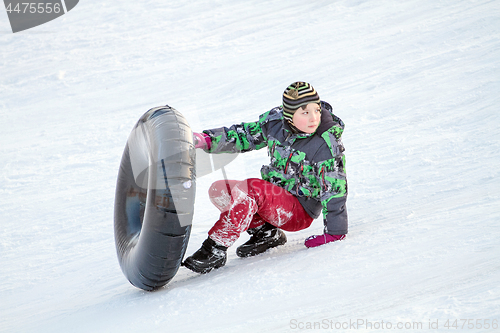 Image of Happy boy with snow tube