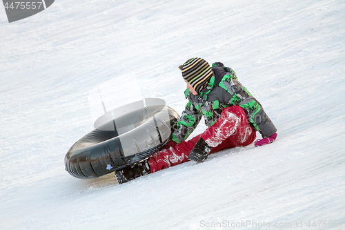 Image of Happy boy with snow tube