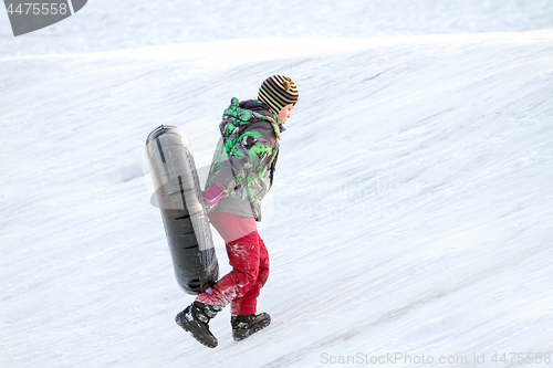 Image of Happy boy with snow tube