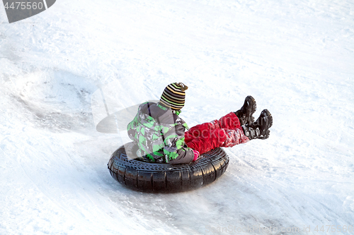 Image of Happy boy with snow tube