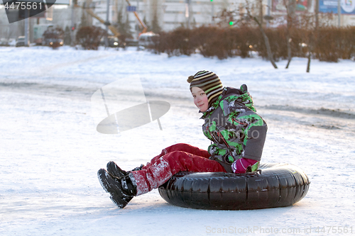 Image of Happy boy with snow tube