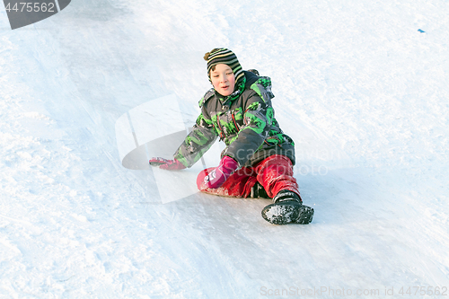 Image of Happy boy with snow tube