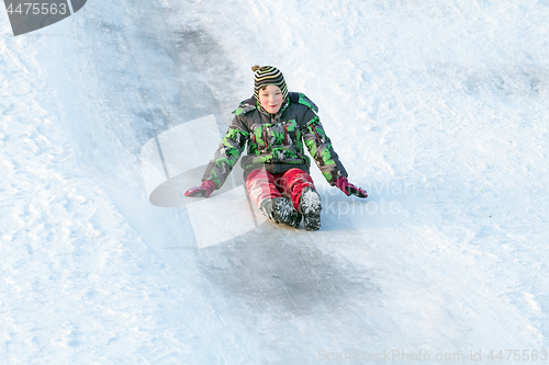 Image of Happy boy with snow tube