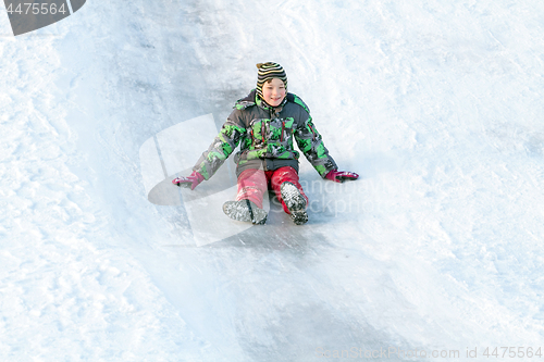 Image of Happy boy with snow tube