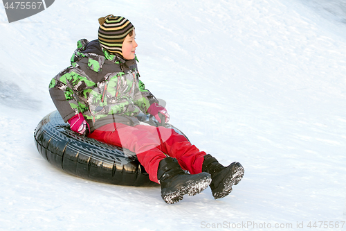 Image of Happy boy with snow tube