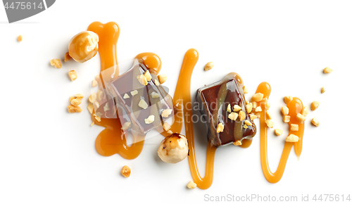Image of chocolate candies decorated with caramel sauce and nuts
